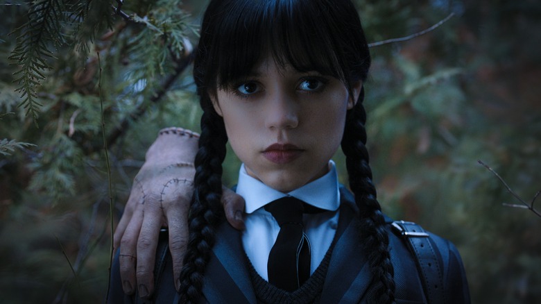 Jenna Ortega as Wednesday Addams with Thing (hand)