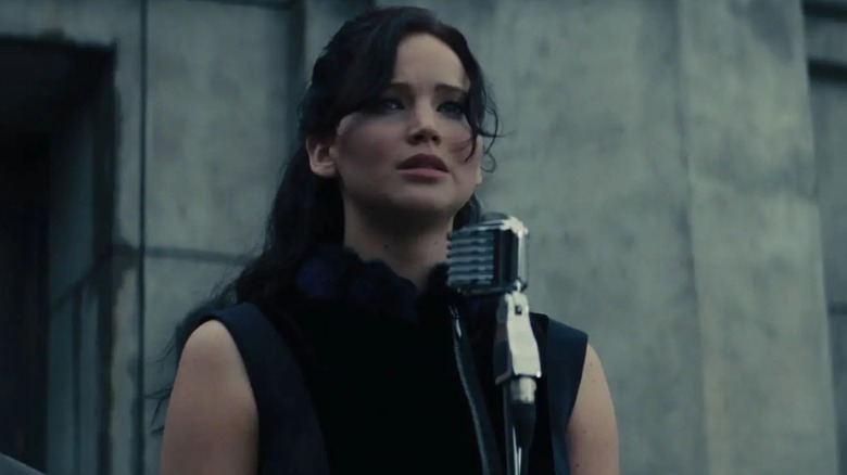 Katniss standing in front of microphone