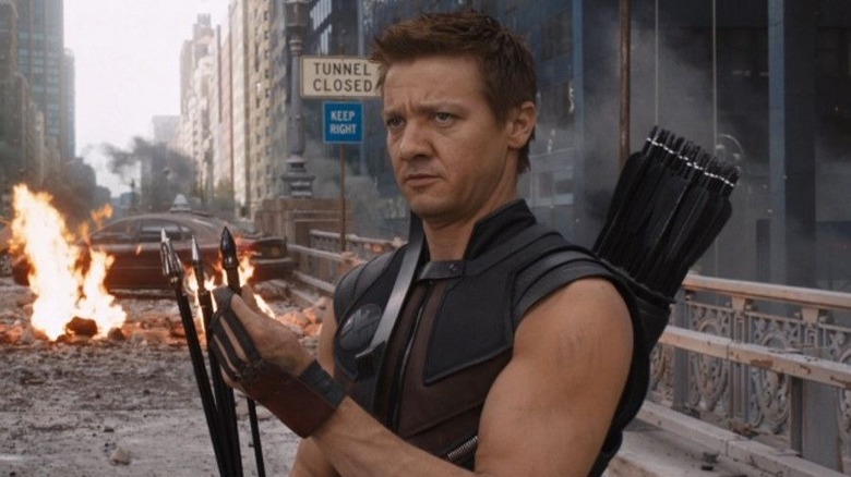 Hawkeye readying a bow next to fire