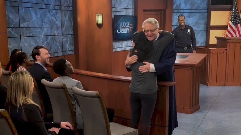 Jerry Springer hugging a woman
