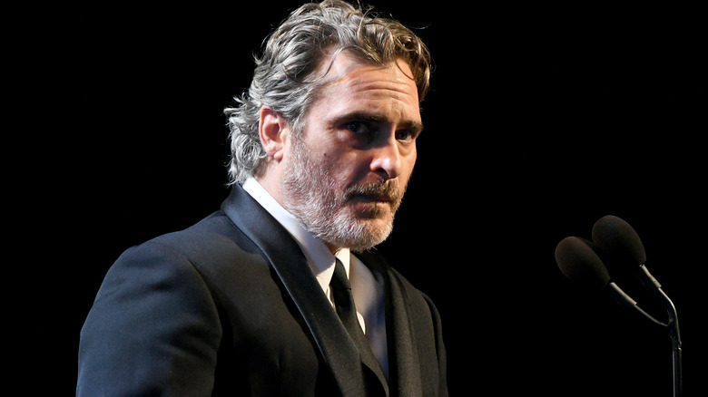 Joaquin Phoenix in suit talking