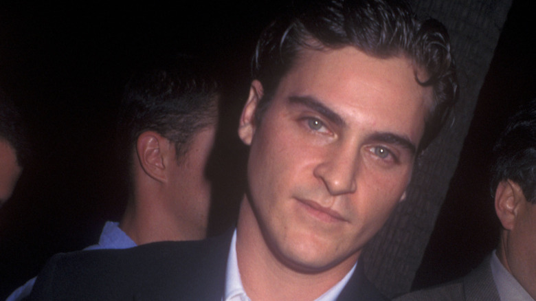 Younger Joaquin Phoenix wearing suit