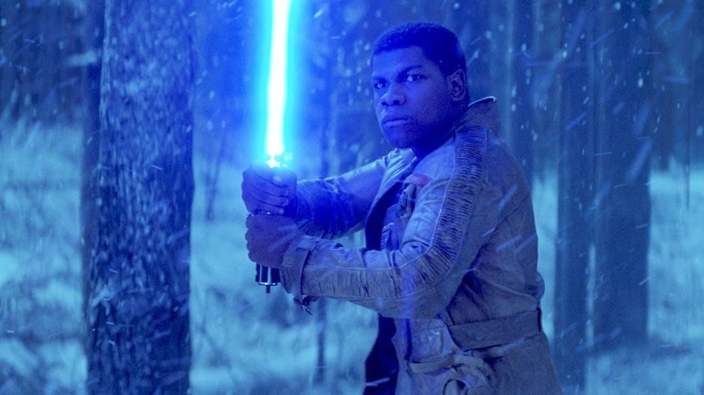 Finn picks up a lightsaber in "The Force Awakens."