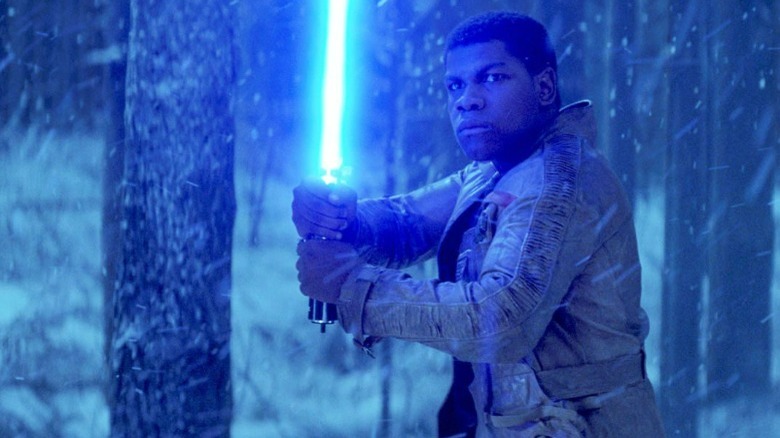 Finn holding a lightsaber