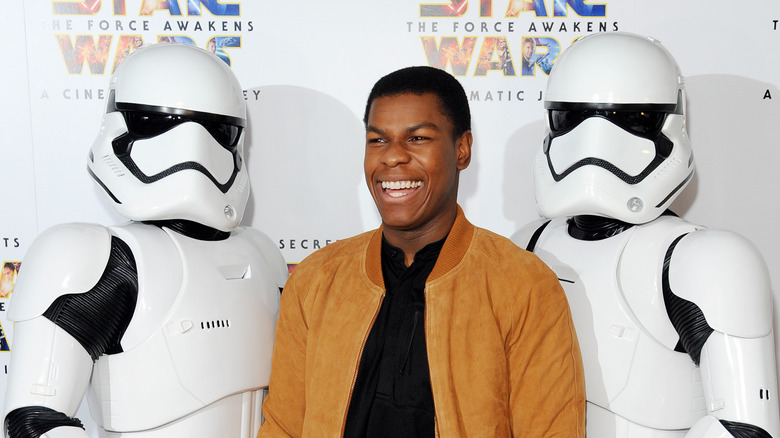 John Boyega smiling event with Stormtrooper