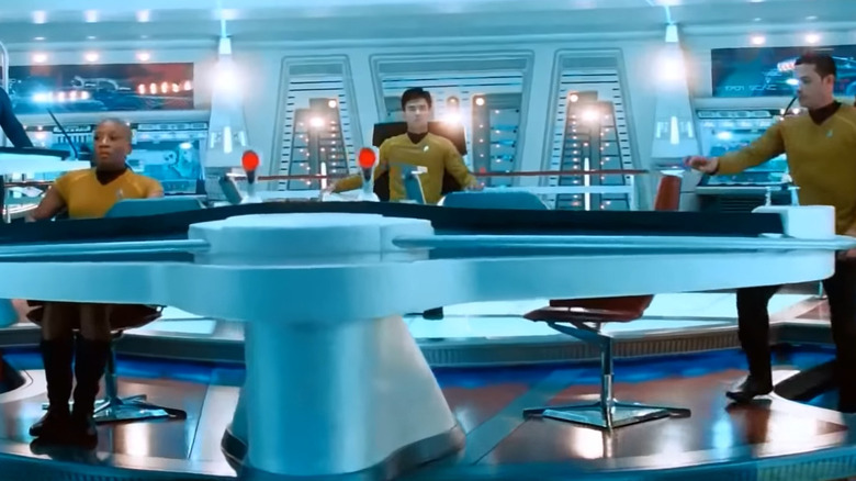 Sulu in the captain's chair in Star Trek