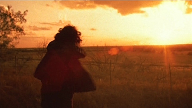 Leatherface swinging his chainsaw maniacally against the sunrise