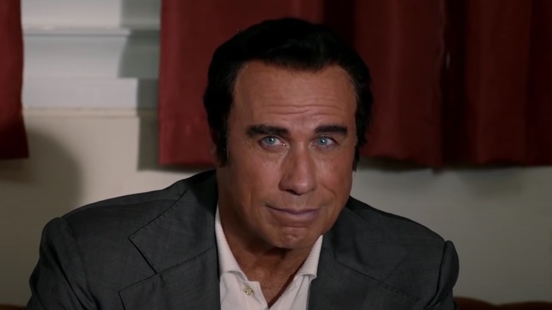 John Travolta smirking