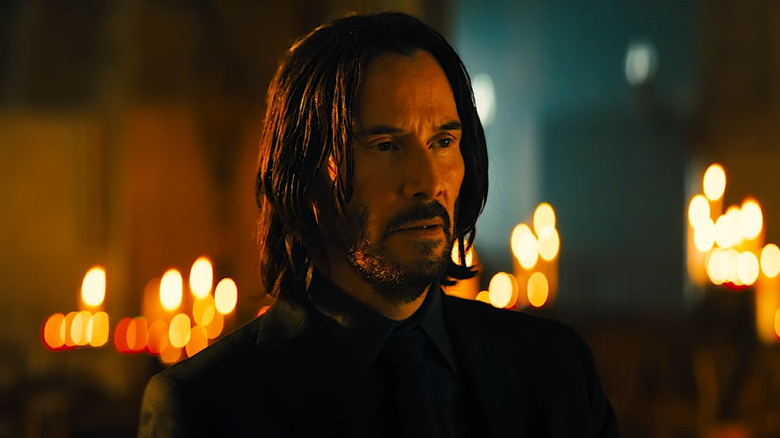 John Wick sitting in a church