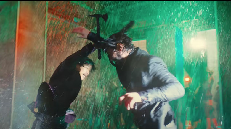 John Wick fighting man with ax