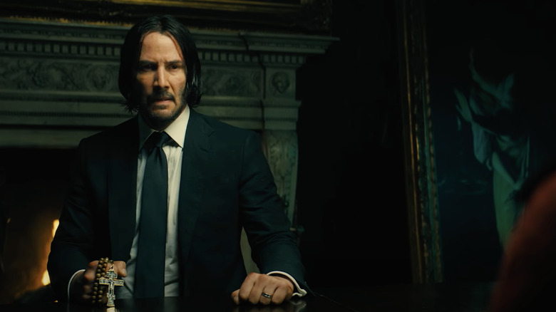 John Wick holds a rosary 