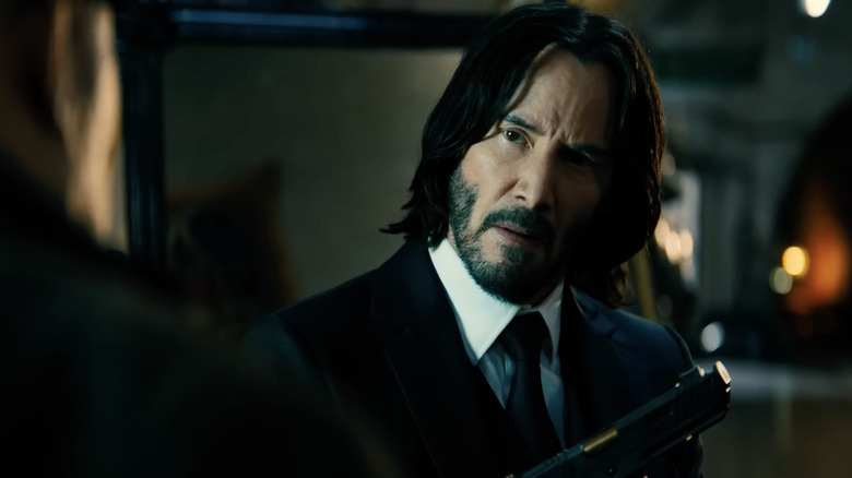 John Wick holds a gun