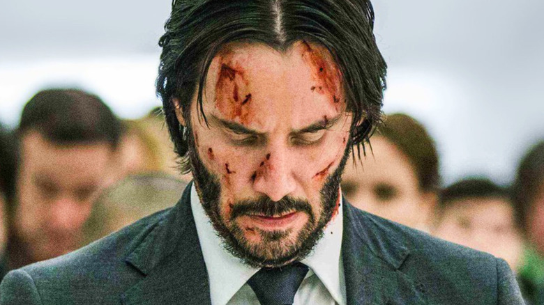 John Wick looking downward cut face