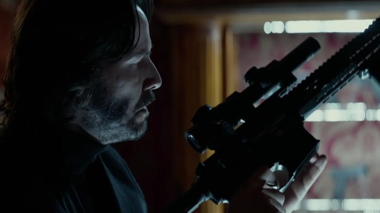 John Wick staring at a gun