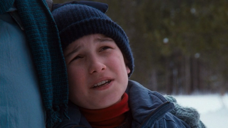 Russ Griswold hugging his father while they stare at their perfect Christmas tree