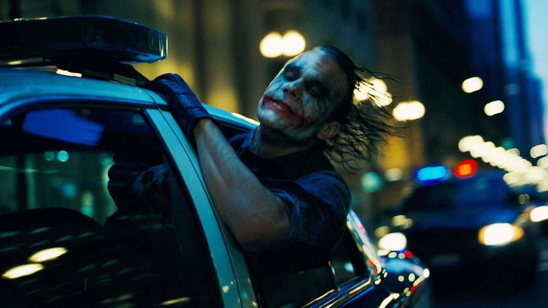 Joker leaning out car window