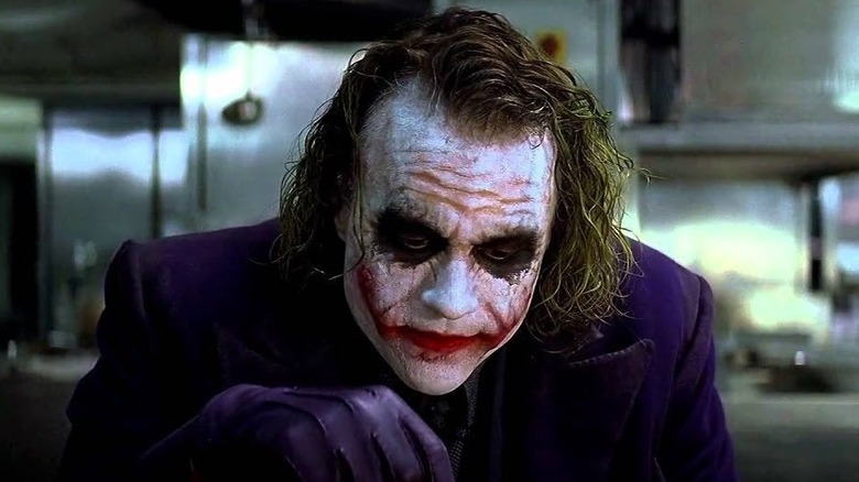 The Joker looks down, annoyed