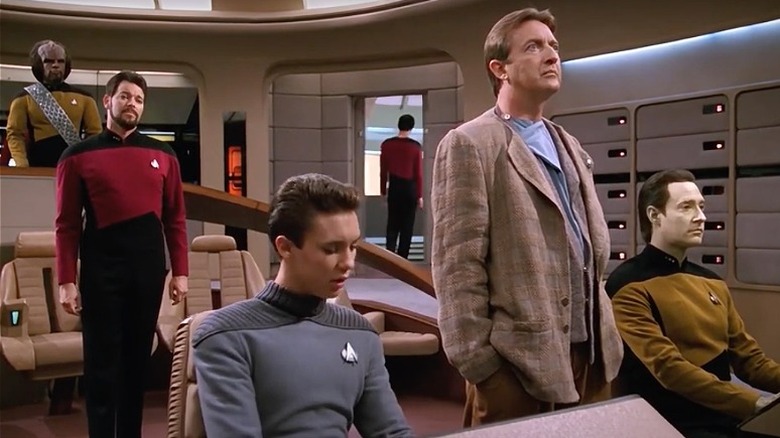 Commander Riker guiding Wesley