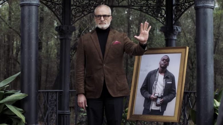 Dean Armitage standing next to a picture of Chris Washington