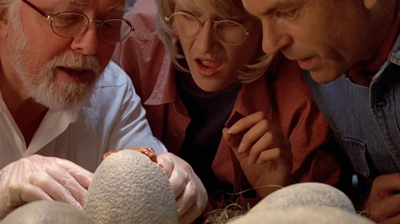 Hammond studying his dinosaur egg 