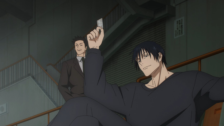 Toji holds up his ticket