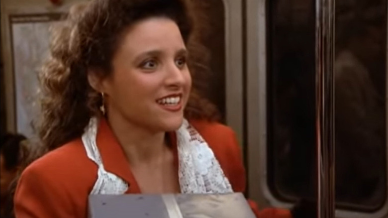 Elaine looks worried on subway