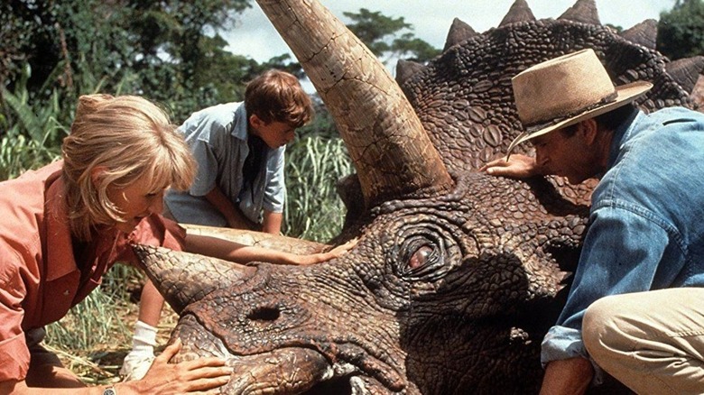 Jurassic Park characters tending to a sickly dino