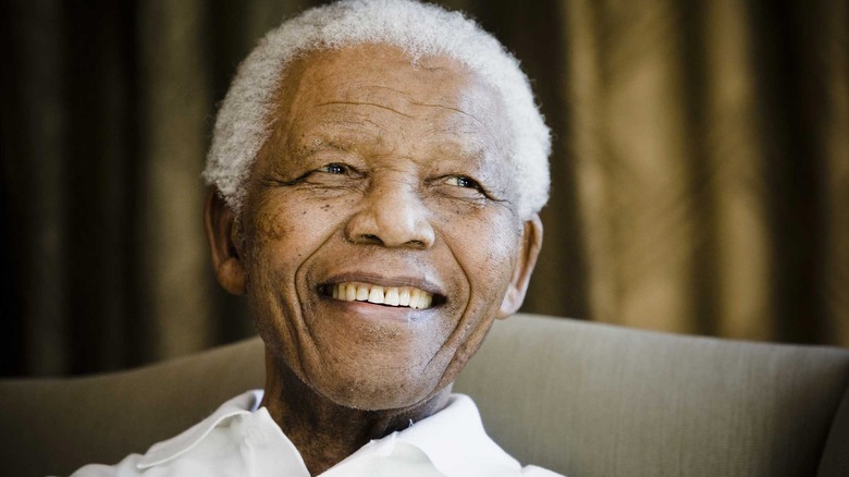 Nelson Mandela smiling in chair