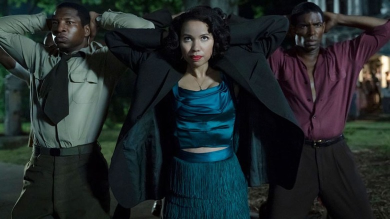 Jurnee Smollett kneels in Lovecraft Country