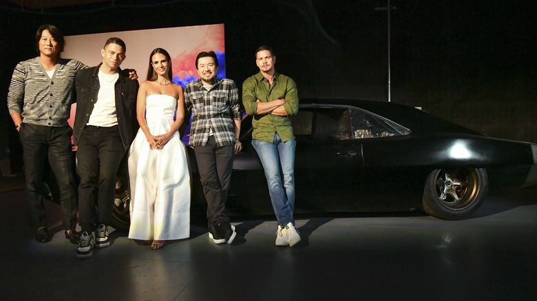 Justin Lin and F9 cast lean on car