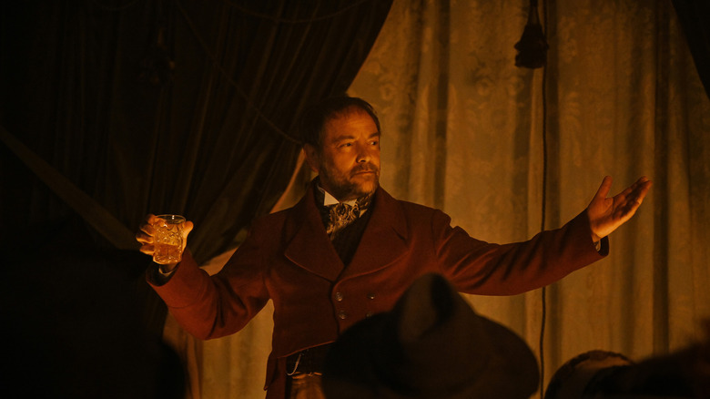 Mark Sheppard in character with drink