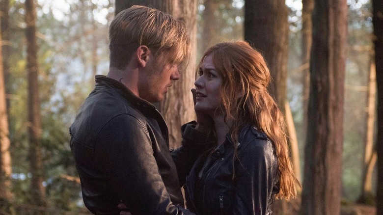 Jace caressing Clary