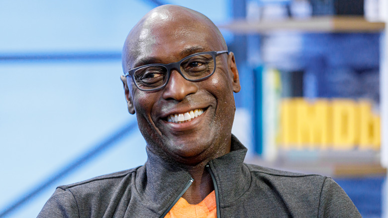 Lance Reddick smiles on TV interview