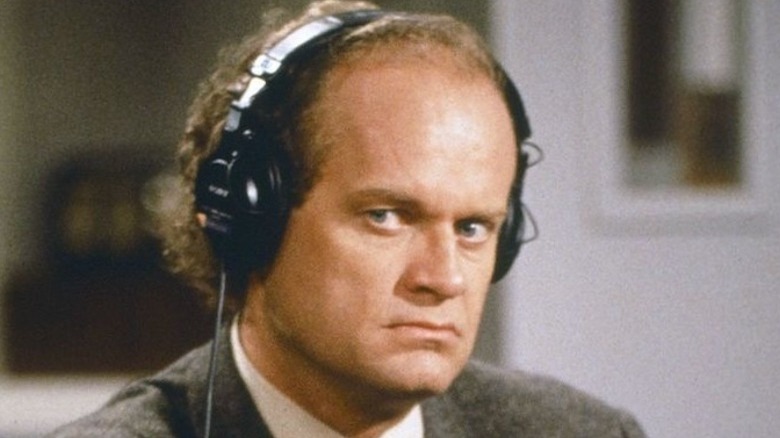 Frasier frowning with headphones on