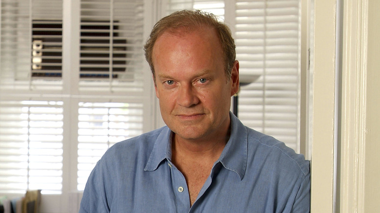 Kelsey Grammer leaning on wall