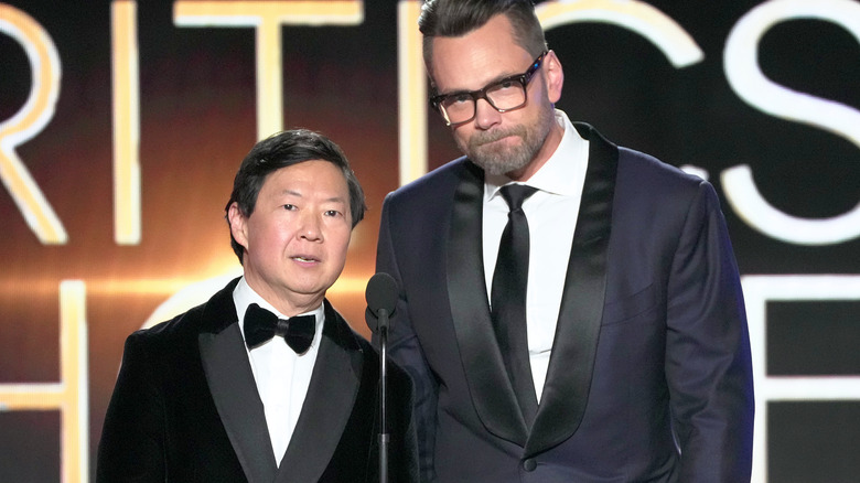 Joel McHale and Ken Jeong in front of microphone