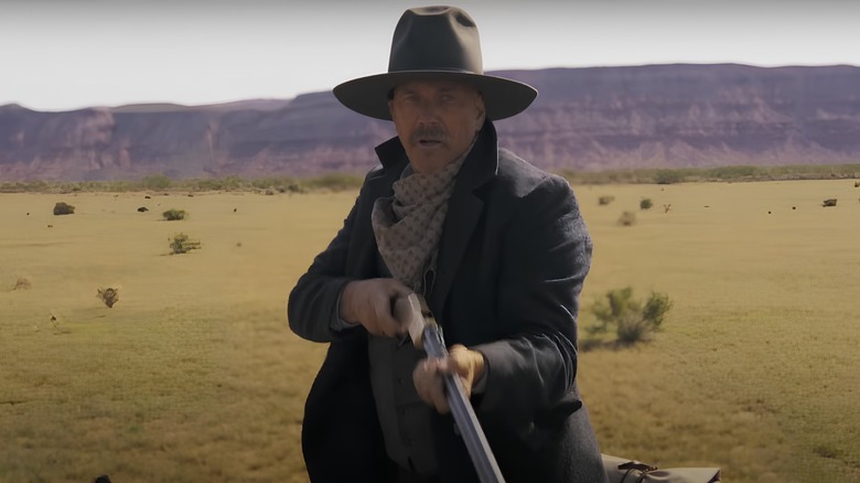 Kevin Costner's character holding gun