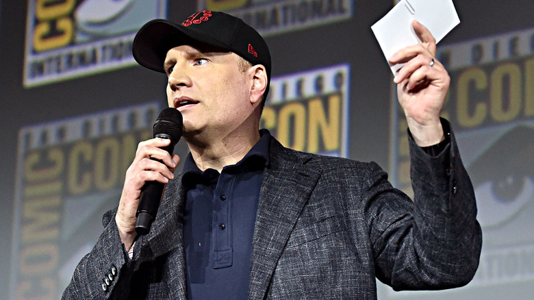 Kevin Feige holding a microphone