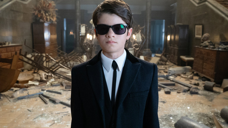 Artemis Fowl standing in his ruined mansion (2020)