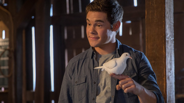 Andy Duckerman holding a dove in "Magic Camp" (2020)