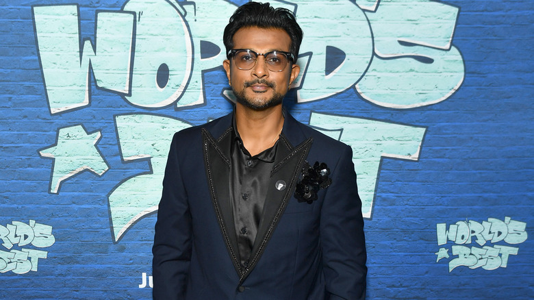 Utkarsh Ambudkar posing against wall