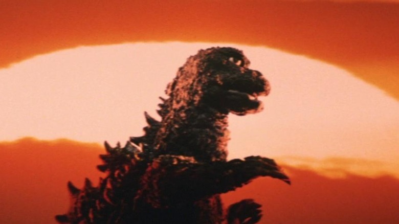 Godzilla walking at sunset