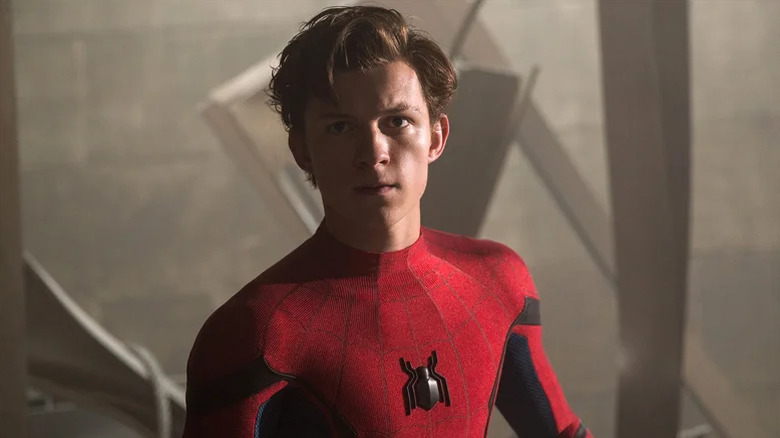 Peter Parker as Spider-Man unmasked standing in wreckage in Spider-Man: Homecoming (2017)