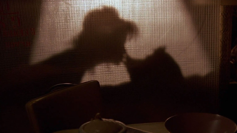 Lea Thompson kissing Howard the Duck in silhouette