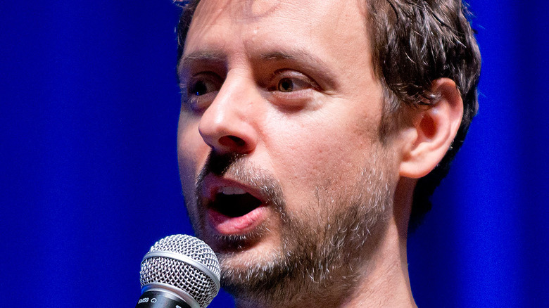 Kyle Dunnigan speaking into a microphone