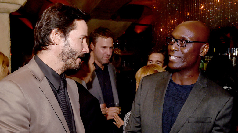 Keanu Reeves and Lance Reddick speaking at event