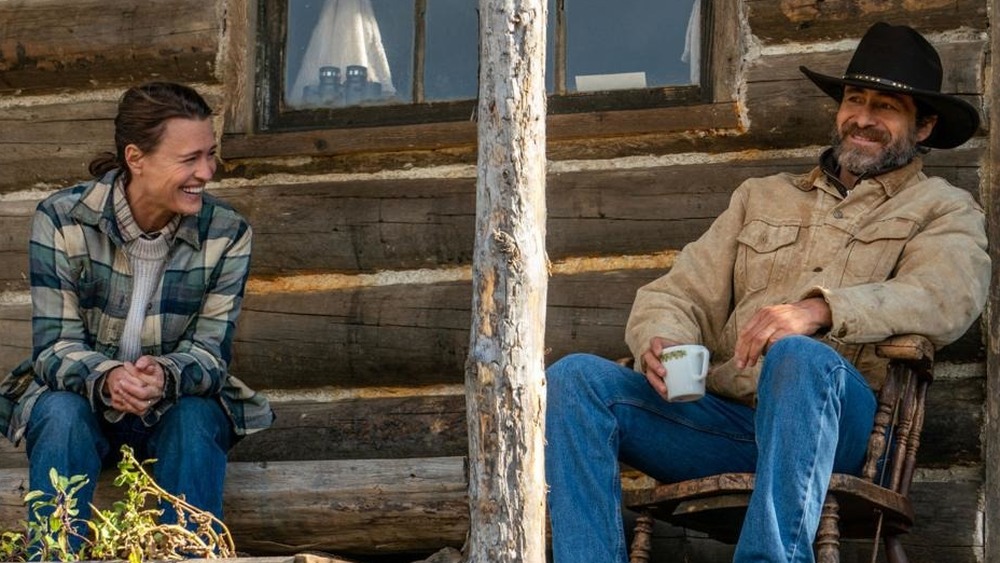 Robin Wright and Demian Bichir laugh on a porch