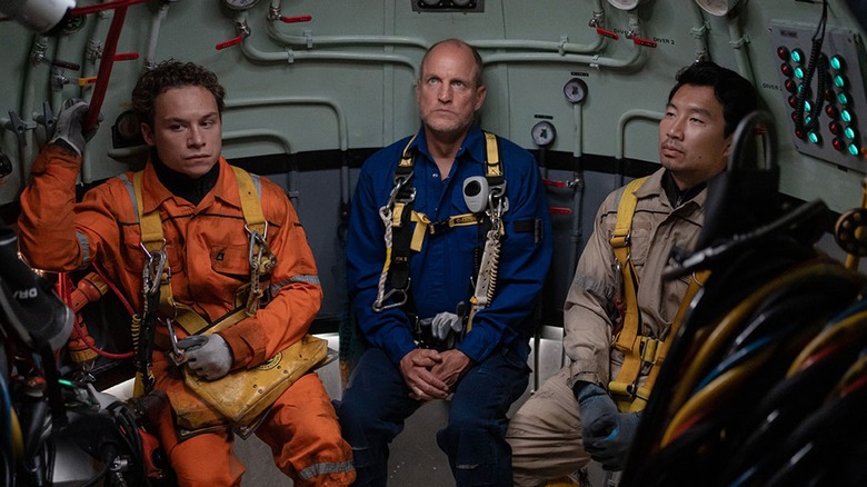 Finn Cole as Chris Lemons, Woody Harrelson as Duncan Allcock, and Simu Liu as David Yuasa sitting in submarine