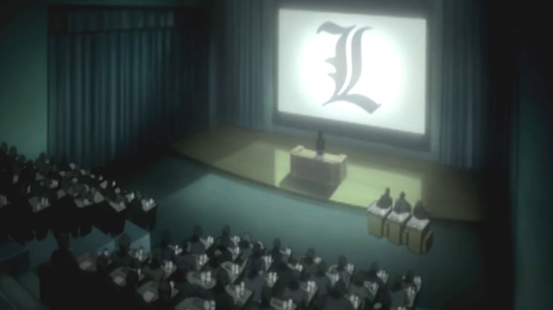 A group in an auditorium hears about the power known as Death Note