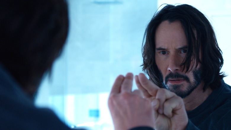 Keanu Reeves touches mirror